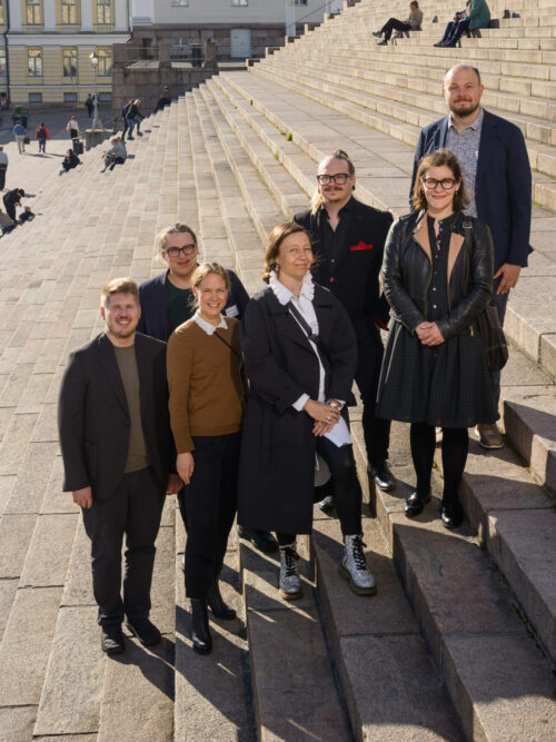 Seven people standing on stairs